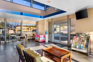a living room with a table and a dining room at Americas Best Value Inn Vacaville in Vacaville