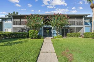 a house with a pathway in front of a yard at Near Disney Stylish 2BR with Pool in Orlando