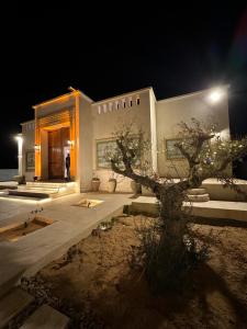 a man standing in front of a building at night at Dar Ellet Khadija in Sfax +22 photos