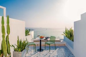 a table and chairs on a balcony with a view of the ocean at Miyue shenzhen Santorini Sea View Resort in Dapeng