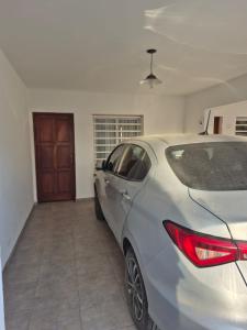 a silver car parked in a garage with a door at El Punto Las Varillas in Las Varillas