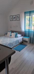 a bedroom with a bed and a table in it at Hortenzia Apartments in Hvar