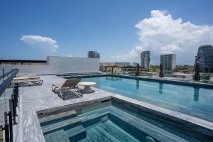 a swimming pool on the roof of a building at Luxury Penthouse with Private Rooftop in Cancún