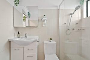 a bathroom with a shower and a toilet and a sink at Courtyard Double Room in Peakhurst - Central Location - Shared Bathroom in Peakhurst