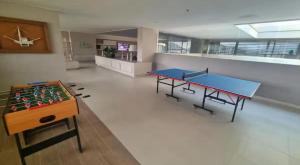 a room with two ping pong tables in it at Apto Reserva del Mar,Rodadero sur in Estación El Salto