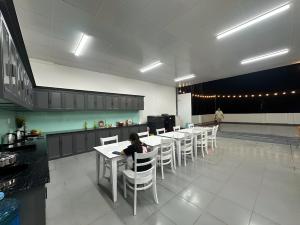 a person sitting at a table in a kitchen at Công Ty TNHH SẢN XUẤT & THƯƠNG MẠI PHÚC ĐẠT in Xom Ông Linh