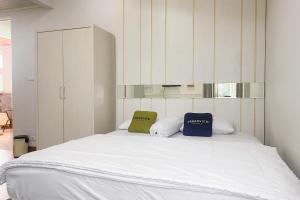 a bedroom with a large bed with two pillows on it at Urbanview Hotel Hakobox Syariah Lampung by RedDoorz in Bandar Lampung