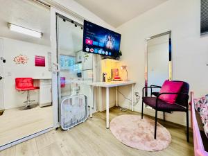 a room with a table and a chair and a tv at 1 Bedroom Apartment 10 Minutes to SeaTac Airport in Seattle