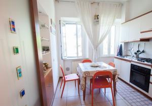 a kitchen with a table and chairs in a kitchen at La Persiana in Ancona