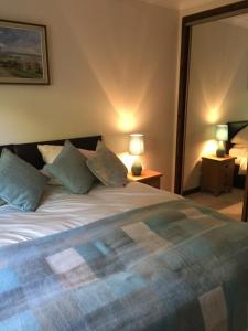 a bedroom with a large bed with pillows on it at Cottage at the Hollow in North Middleton