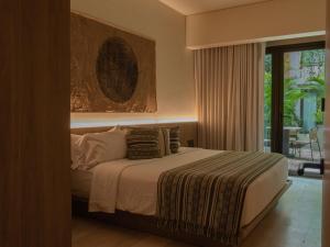a bedroom with a bed and a large window at Osh Hotel Cartagena in Cartagena de Indias