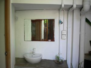 a bathroom with a sink and a mirror on the wall at Piccolo Villa in Hikkaduwa +56 photos