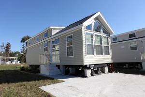 a house with a large window on the side of it at Sherwood Forest Premium Loft Cottage 13 in Kissimmee