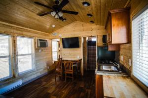 a kitchen with a table and a ceiling fan at Verde Valley Lawn Cottage 10 in Cottonwood