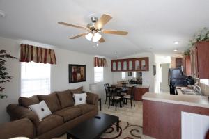 a living room with a couch and a ceiling fan at Lake Magic Cottage 1 in Kissimmee