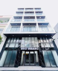 a building with a sign on the front of it at BRIO Urbano Apartment in Da Nang