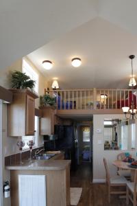 cocina con armarios de madera y comedor en Lake Magic Loft Cottage 11, en Kissimmee