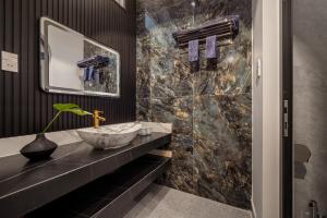 a bathroom with a sink and a mirror at Mai Villa - My Khe Beach in Da Nang +27 photos