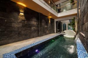 a swimming pool in a house at Mai Villa - My Khe Beach in Da Nang