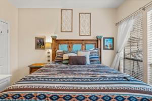 a bedroom with a large bed with colorful pillows at UT Retro Getaway- 2 King Beds, Workspace, F1 & Football in Austin