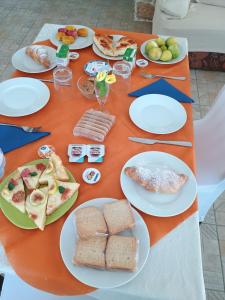 a table with plates of food on it at Oasi di san Benedetto in Castellaneta +12 photos
