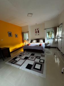 a bedroom with a bed and a large rug at Aonang Private House in Ao Nang Beach