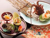 a table with two plates of food on it at Mamesentaigetsu in Minamichita