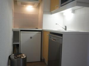 a small kitchen with a sink and a dishwasher at Appartement 6 pers, 2 ch, proche pistes et commerces - FR-1-807-123 in Saint-François-Longchamp +7 photos