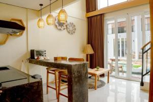 a kitchen with a counter and a table in a room at Tropical Boho Loft Villa with Sofa Beds in Canggu