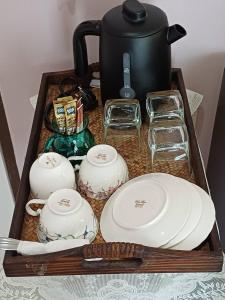 a tray with plates and cups and a tea pot at 168Hostel Airport@Phuket in Thalang +20 photos