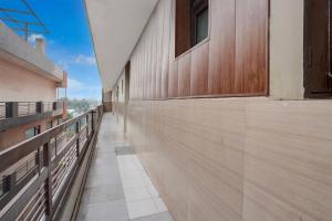 an empty hallway of a building with a wooden wall at Hotel O by OYO Sector 58 Mohali Formerly Hotel Alpha in Mohali
