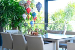 a dining room with a table and chairs and lanterns at Waterfront Stay at Sunshine Villa in Maroochydore