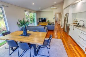a kitchen and living room with a wooden table and chairs at Kiali 3 Cape Villas Dunsborough in Dunsborough +28 photos