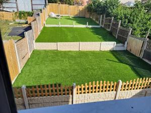an aerial view of a backyard with a fence and grass at Barnsley cozy home in Little Houghton
