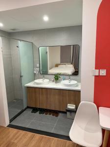 une salle de bain avec deux lavabos et un grand miroir dans l'établissement Homestay Ocean City, Kinh Đô 5-15, à Ðình Loan