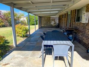 a picnic table and chairs on a patio at Lancelin Beach house in Lancelin