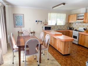 a kitchen with a table and chairs in a kitchen at Lancelin Beach house in Lancelin