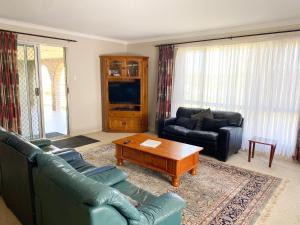 a living room with two couches and a coffee table at Lancelin Beach house in Lancelin