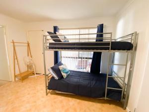 a bedroom with a bunk bed in a room at Ocean Spray in Lancelin