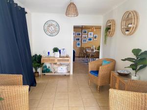 a living room with chairs and a table at Ocean Spray in Lancelin