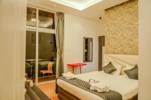 a bedroom with a bed and a window at Le Karaj Meadows in Lovedale