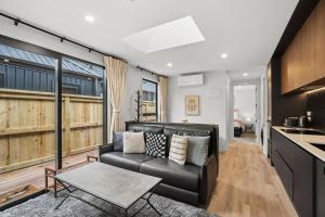 a living room with a couch and a table at Mountain Escape by Remarkables 9 | 2-bedroom unit in Frankton Wharf