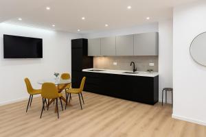 a kitchen and dining room with a table and chairs at Apartamentos TriBeCa Centro IV in Albacete