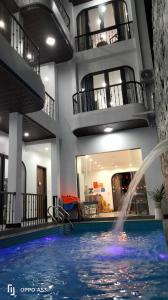 a swimming pool with a fountain in a building at Phố Cổ Homestay in Ninh Binh