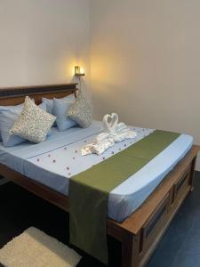 a bed with a white bow on top of it at The Pearl Safari Resort in Udawalawe