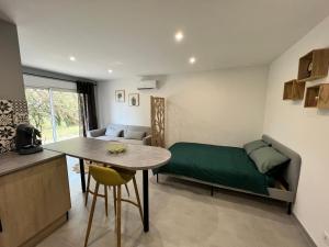 a small room with a bed and a table in it at appartement Mondragon in Mondragon