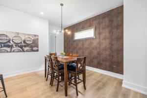 a dining room with a table and chairs at Modern new 4BR Home near NoDa & Downtown in Charlotte