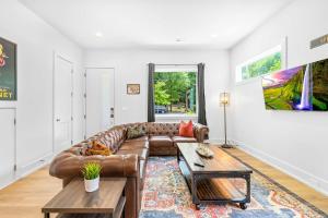 a living room with a couch and a table at Modern new 4BR Home near NoDa & Downtown in Charlotte