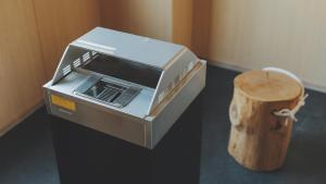 a toaster oven sitting next to a wooden stump at SOKI KANAZAWA - Vacation STAY 40338v in Kanazawa