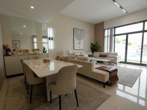 a living room with a couch and a table at The Bay Villa in Fujairah